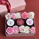 Pink gift box with flowers and three candles labeled "I", heart, and "U".