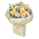 Bouquet of pink and cream roses, lisianthus, and chamomile flowers.
