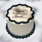 White cake with black frosting border, pink "22 happy birthday Baba" writing.
