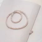 Pearlie pearl necklace and matching earrings on a white background.