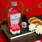 Reed diffuser, ruby essential oil, bubble candle, dried oranges, and diffuser reeds.