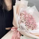 Pink baby's breath bouquet with pink ribbon and diffuser.