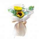 Small bouquet of sunflowers with eucalyptus leaves, wrapped in white paper and tied with a gold ribbon.
