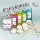 Home Lab reed diffuser set with 5 colored diffuser bottles and rattan balls.