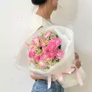 Pink carnation bouquet with baby's breath and bunny tail grass.