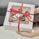 Christmas-themed cookie gift box with red ribbon and polar bear tag.