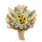 Sunflower and baby's breath bouquet wrapped in brown paper.