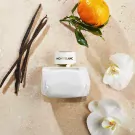 Montblanc Signature Eau de Parfum bottle with vanilla, orange, and orchid on a textured background.