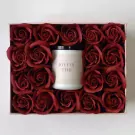 Red roses surround a candle with "JOYFUL TIME" label in a rose gold gift box.