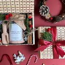 Christmas gift set in bamboo box with herbal salt, cinnamon, pine branches, and berries.