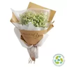A bouquet of white flowers wrapped in brown paper with "Gorgeous You" printed on it.