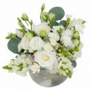 White floral arrangement in a silver vase with roses, carnations, snapdragons, and eucalyptus.