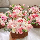Wicker baskets overflowing with pink and white soap flowers.