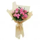 Pink lotus flowers in a golden wrap with a ribbon tie.