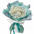 Bouquet of white baby's breath with blue hydrangeas, wrapped in teal and gray paper.