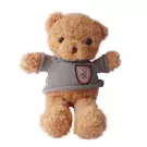 A plush brown teddy bear wearing a gray sweater with a pink badge.