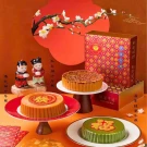 Red bean coconut nian gao gift set with festive decor, mini figures, and plum blossoms.