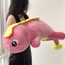 Large pink plush dinosaur toy with yellow accents, held by a person.