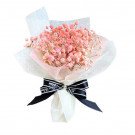 Bouquet of dried pink baby's breath flowers wrapped in white and pink paper, tied with a black ribbon.