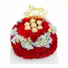 Round red flower cake topped with Ferrero Rocher chocolates and "Happy Birthday" topper.