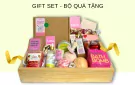 Gift set in a wooden crate with bath bombs, body oil, scrub, and candle.