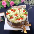 Chocolate mousse cake with white chocolate shavings and fresh strawberries, decorated with a "Honey! Just for you" topper.