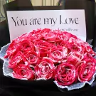 Red and white striped roses bouquet with "You are my Love" card.