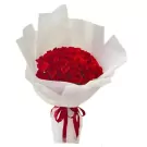 A large bouquet of 66 red roses wrapped in white paper and tied with a red ribbon.