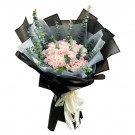 Pink roses and eucalyptus bouquet in black and grey wrapping with a white ribbon.