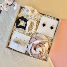 Gift box with scrunchies, heart earrings, hair clip, and striped scarf.