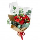Brick red roses and carnations bouquet with eucalyptus leaves, wrapped in brown paper and tied with a red ribbon.
