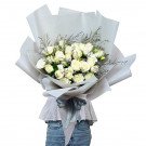 Bouquet of 36 white roses wrapped in light gray paper with a gray ribbon.