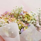 Pastel hydrangea and baby's breath bouquet wrapped in pink paper, Korean style.