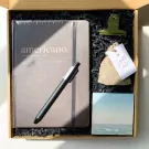 Gift box with Americano notebook, pen, scented sachet, and sticky notes.