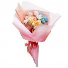 Pastel bouquet with roses, hydrangeas, and gerberas, wrapped in pink paper and tied with a pink ribbon.