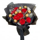 Bouquet of red carnations and Ferrero Rocher chocolates in black wrapping.