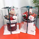 Christmas gift boxes with teddy bears, Santa, and festive decor, lit with fairy lights.