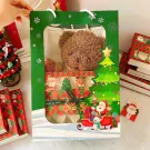 Christmas gift bag with teddy bear, Santa, reindeer, and Christmas tree decorations.