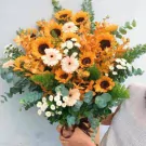 Beautiful wooden box with sunflowers, gerbera daisies, orchids, and eucalyptus.