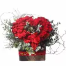 Box of 99 red roses with eucalyptus and decorative twigs in a square box.