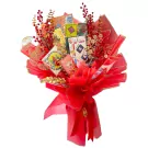 Red and gold Lunar New Year bouquet with game boards, coins, and red berries.