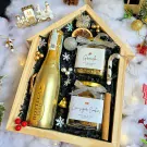 Christmas gift box with Bottega Gold wine, granola, cookies, and festive decorations.