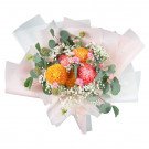 Vibrant bouquet of orange and pink chrysanthemums, baby's breath, and greenery.