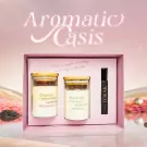 Aromatic Oasis gift set with two candles and a perfume vial in a pink box.