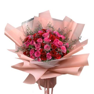 A bouquet of red and pink roses, wrapped in pink paper.