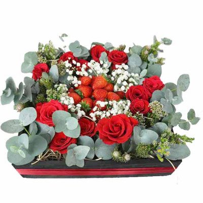 A rectangular box of red roses and strawberries, with baby's breath and eucalyptus.