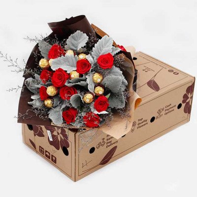 Bouquet of red roses and Ferrero Rocher chocolates in a box.