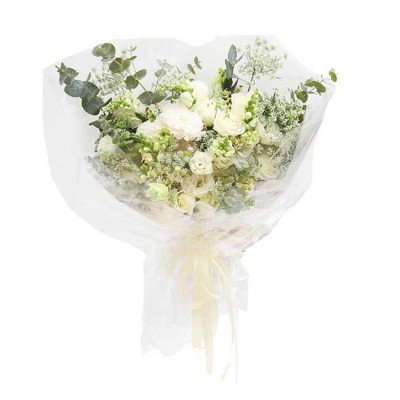 White flower bouquet wrapped in cellophane with a yellow ribbon.