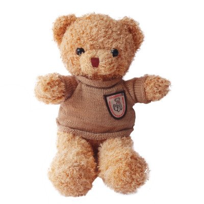 A fuzzy brown teddy bear in a brown sweater with a patch.