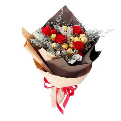 Bouquet with red roses and Ferrero Rocher chocolates, wrapped in brown and tan paper with red ribbon.